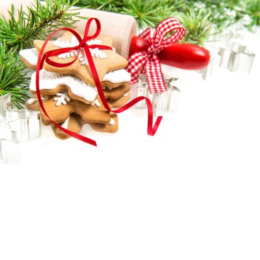 Gingerbread cookies with red decoration and hristmas tree branch