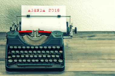 Typewriter with white paper page. AGENDA 2016