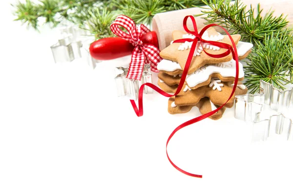 Gingerbread cookies with Christmas tree branches over white — Zdjęcie stockowe