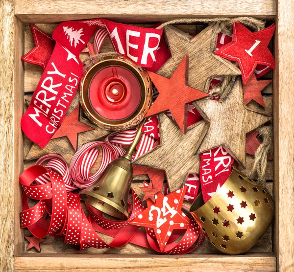 Christmas box decorations wooden stars, red ribbons and burning — Stock Photo, Image