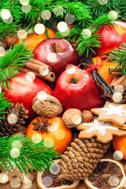 Christmas food background. Apples, cookies, spices, lights