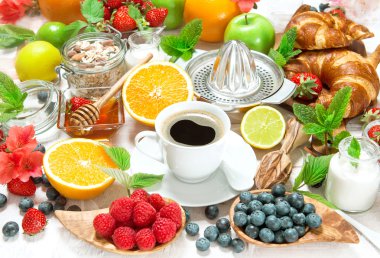 Breakfast with coffee, croissants and fruits. Healthy food