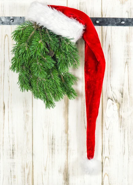 Red hat and green christmas tree branch. Vintage decoration — Stok fotoğraf