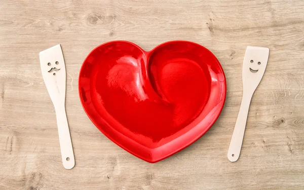 Kitchen utensils red plate. Cooking with love — Stock Photo, Image