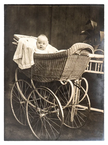 Cute baby in vintage buggy. Vintage picture — Stock Photo, Image