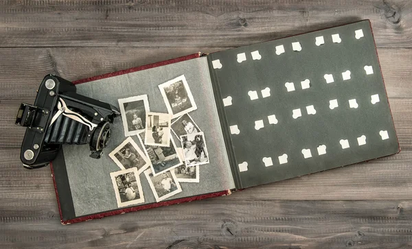 Vintage camera and photo album with old pictures — Stock Photo, Image