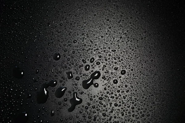 Siyah arkaplan arkaplanındaki su damlaları soyut doku arkaplanı