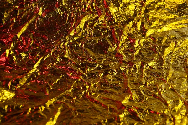abstract background texture metal aluminum foil gold yellow and red colors