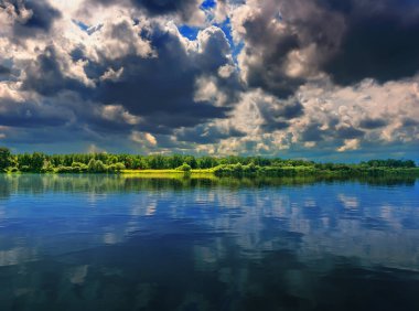 Nehir ve fırtına bulutlarıyla dolu güzel, dramatik bir yaz manzarası. Güzel, güzel, dramatik yaz manzarası, her amaç için harika tasarım..