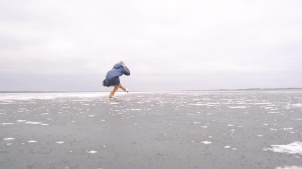 Dziewczyna Kręci Się Łyżwach Figurowych Zamarzniętym Jeziorze Chmurny Mroźny Zimowy — Wideo stockowe