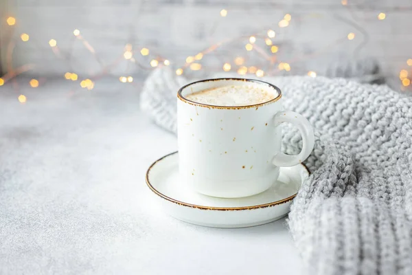 Cup of coffee, scarf and garland. Cozy autumn or winter composition. Scandinavian style — Stock Photo, Image