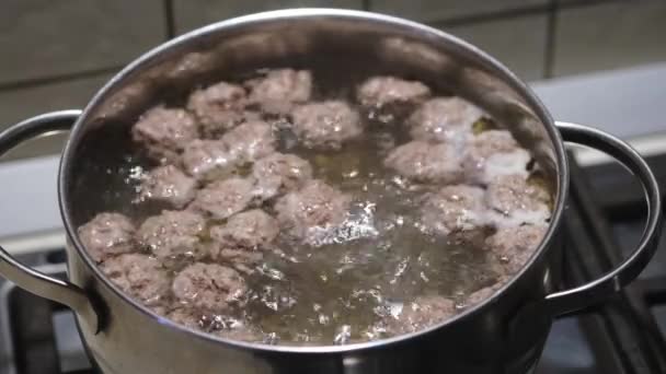 Homemade meatballs in boiling water. Soup preparation process. Close-up. Selective focus — Vídeos de Stock