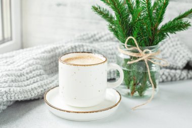 Bir fincan kahve, eşarp ve bir buket köknar ağacı dalı. Sıcak sonbahar ya da kış kompozisyonu. İskandinav tarzı