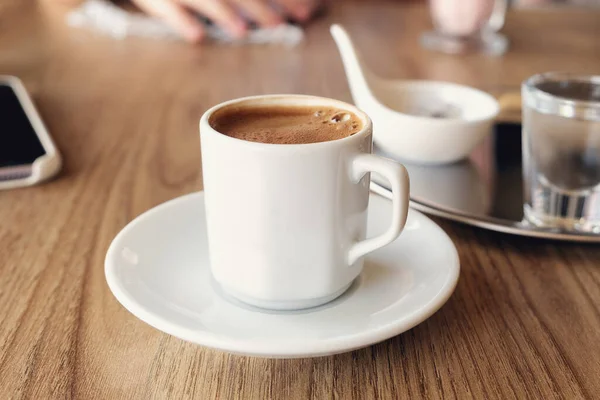 Close-up of traditional Turkish coffee with cold water and Turkish delight. Selective focus - Image