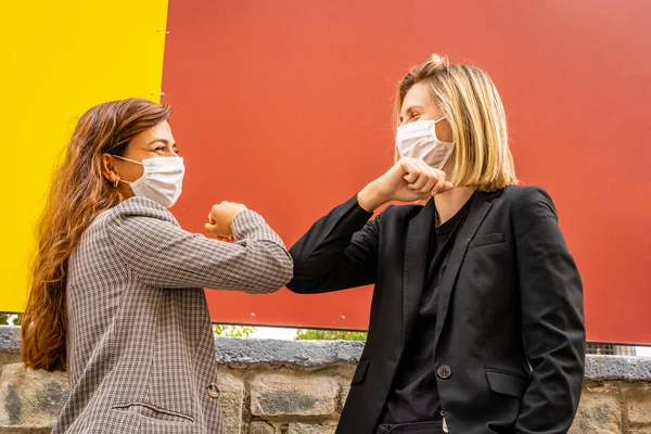 Two Friends in Business Outfit Meet and Do Elbow Greeting, Safe Handshake, Social Distancing Concept