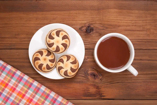 Herbata i ciastka na drewnianym stołem. — Zdjęcie stockowe