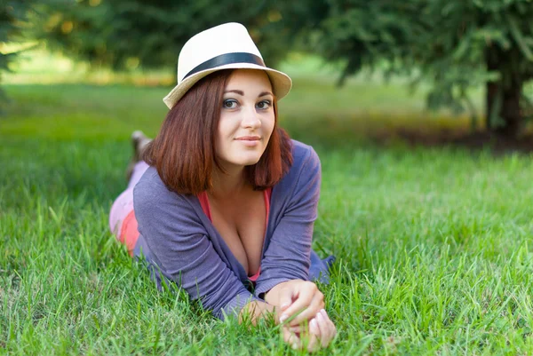 Belle fille couchée dans l'herbe verte . — Photo