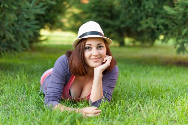 Piękna dziewczyna leżąc na zielonej trawie. — Zdjęcie stockowe