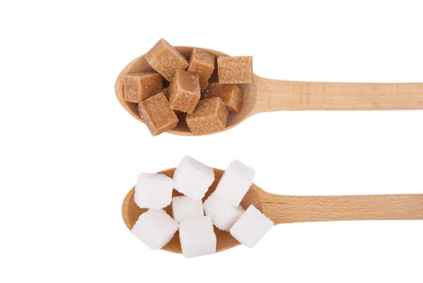 Refined sugar in the spoons on a white background. — Stock Photo, Image