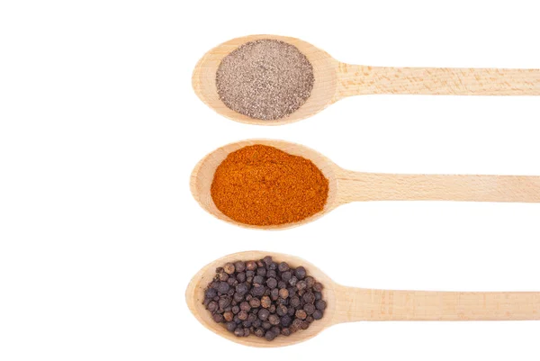 Spices on wooden spoons isolated on white background. — Stock Photo, Image