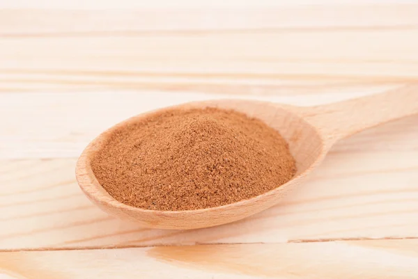 Cinnamon in the spoon on a wooden table. — Stock Photo, Image