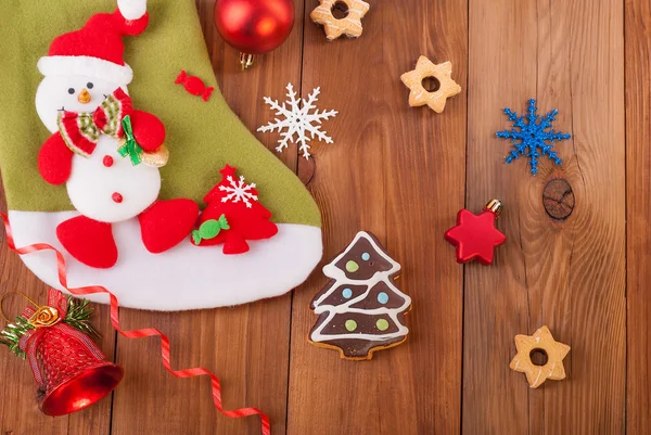 Christmas toys and cookies on a wooden background. — Stock Photo, Image