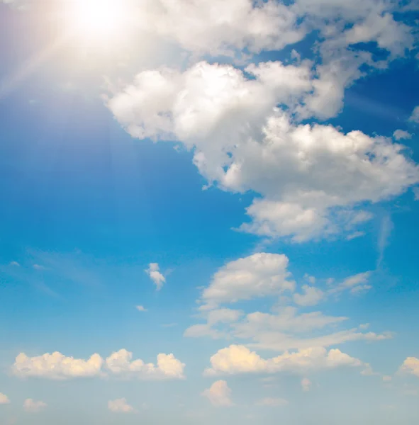 Sun on blue sky with white clouds — Stock Photo, Image