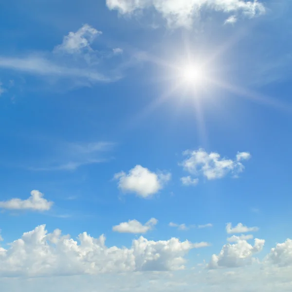 Sun on blue sky with white clouds — Stock Photo, Image