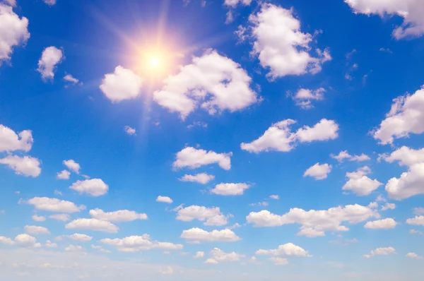 Sun on blue sky with white clouds — Stock Photo, Image