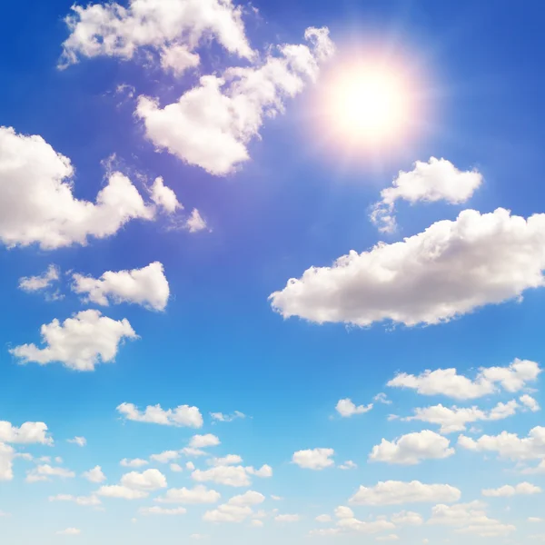 Sun on blue sky with white clouds — Stock Photo, Image