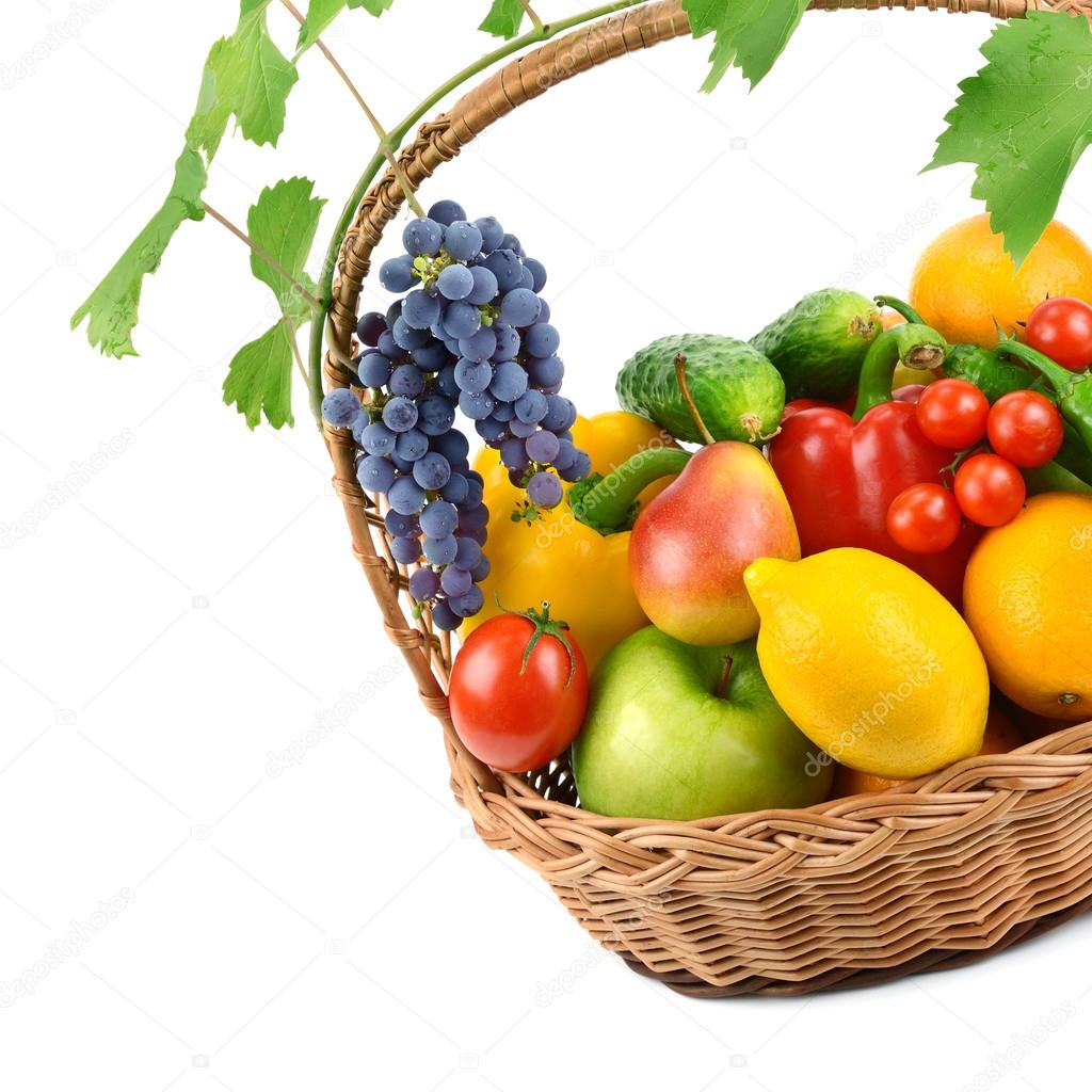 fruits and vegetables in a wicker basket isolated on white backg