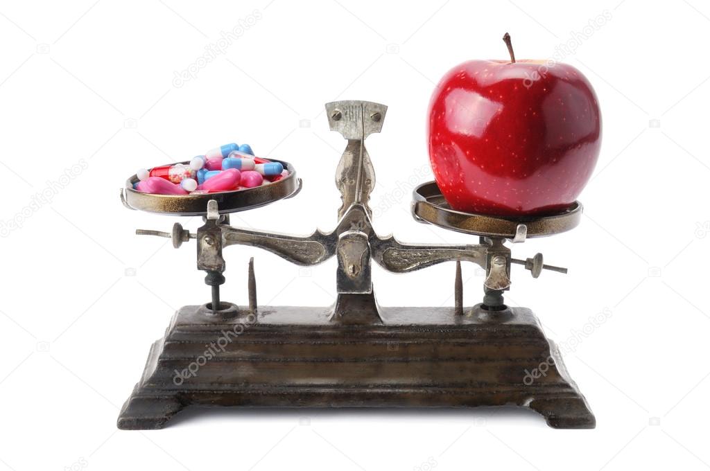 bowls of scales, apple and pills