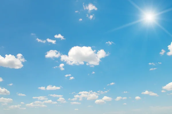 Sun on blue sky with white clouds — Stock Photo, Image