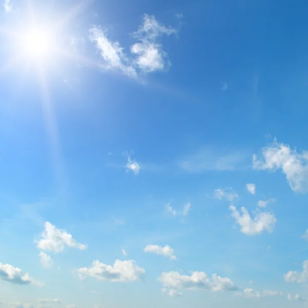 Sun on blue sky with white clouds — Stock Photo, Image