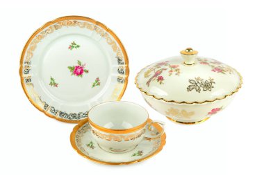 Karmaşık altın detaylarıyla zarif antika sofra takımı ve gül desenleri nostalji hissi uyandırıyor. Tarih, çay kültürü veya ev dekorasyonu üzerine odaklanan editoryal içerik için harika.