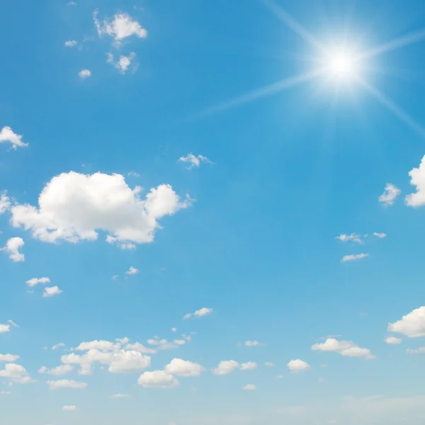 Sun on blue sky with white clouds — Stock Photo, Image