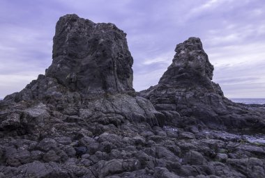 Towering rocks at low tide clipart