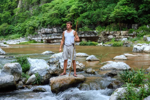 Survivor man in jungle river — Stockfoto