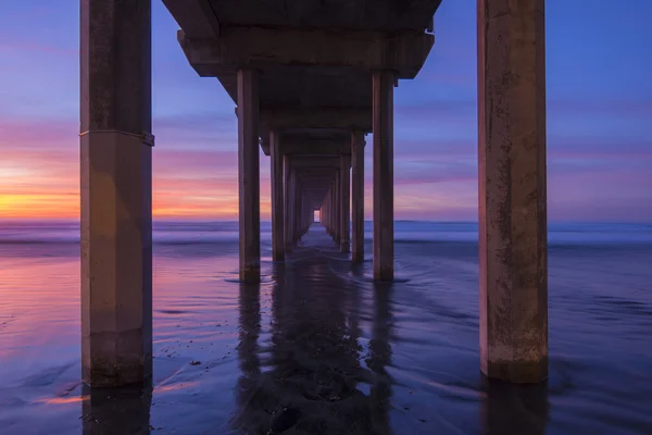 Diminishing perspective under concrete pier — Stock Photo, Image