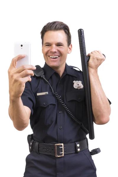 Silly cop taking selfie with baton — 스톡 사진