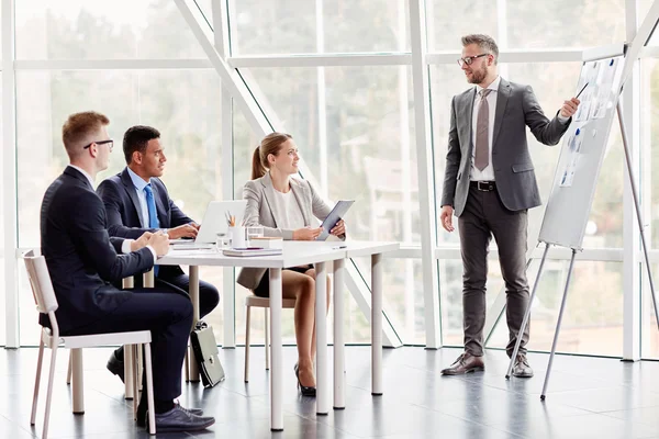 Young managers looking at businessman — Stock Photo, Image