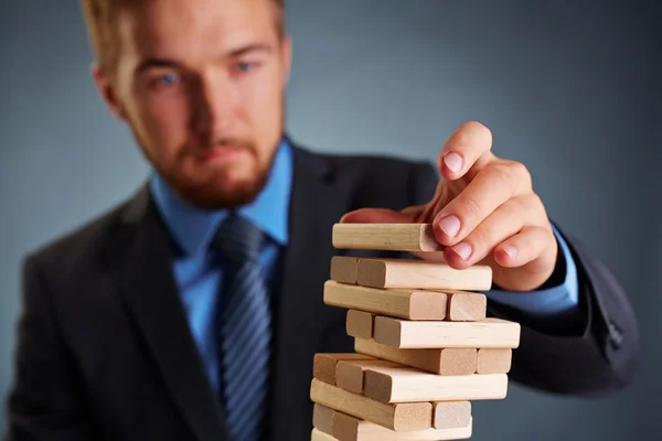 Businessman building tower — Stock Photo, Image