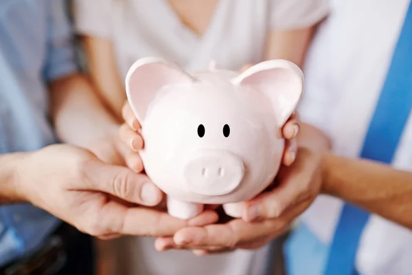 Piggy bank in handen — Stockfoto