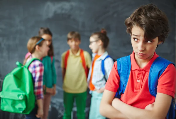 School boy looking at classmates — стоковое фото