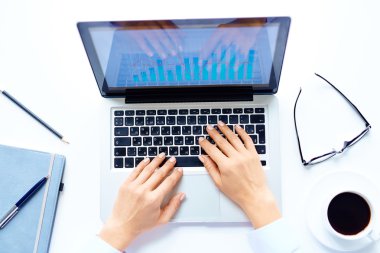 Eller dizüstü bilgisayarda yazıyor.