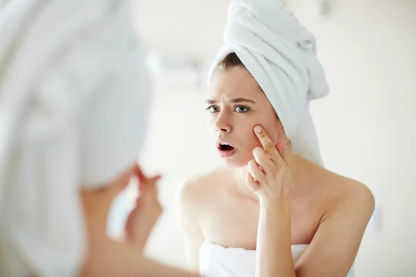 Girl looking at acne — Stock Photo, Image