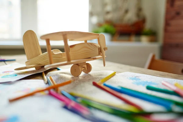 Wooden airplane, pencils — Stock Photo, Image