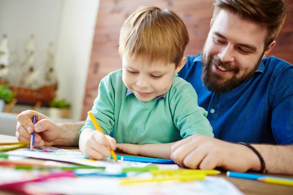 Boy and father coloring pictures — Stock Photo, Image