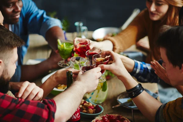 Freunde stoßen mit Cocktails an — Stockfoto