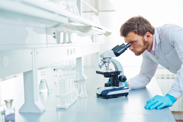 researcher using microscope 